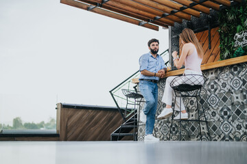 A business couple in the city center discusses new ideas and expansion plans outdoors on a cloudy day. Efficient communication and planning for profit growth show their success as young investors.