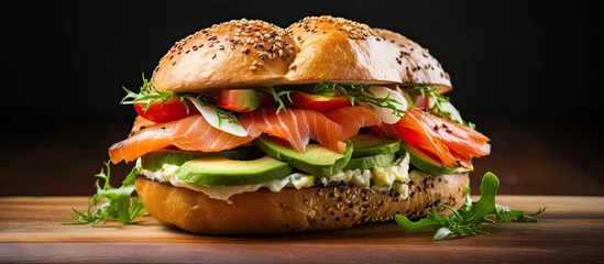 Foto op Aluminium Bagel sandwich with smoked salmon cream cheese avocado and egg. Copy space image. Place for adding text or design © Ilgun
