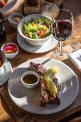 roast with vegetables and a glass of wine