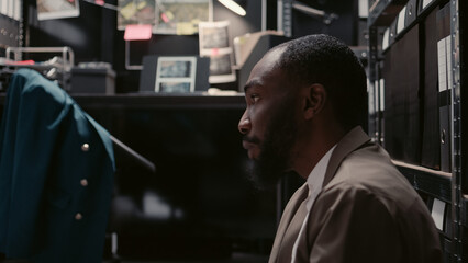 Team of investigators conducting private investigation in incident room, reading statements to...