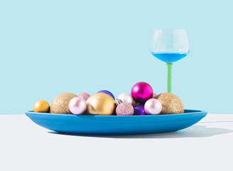 Cocktail in a glass with colorful decorations on an oval plate. Concept of party, special moments, Christmas, new year, Easter, birthday. Copy space.