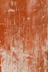 A rich, red wooden surface bears the beautiful marks of time and weather, offering a textured backdrop with a story.