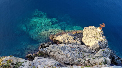 Sea rock on the seashore with Orthodox cross