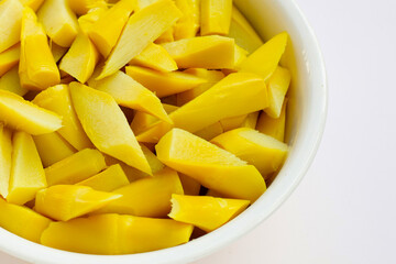 Preserved bamboo shoot in white bowl on yellow background.