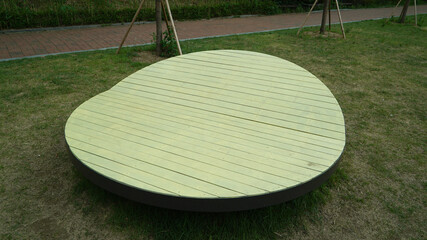 Curved circular bench made of painted wood in a public park