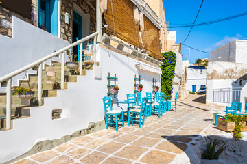 Tavern in narrow street with typical Greek style architecture in Kimolos village, Kimolos island,...