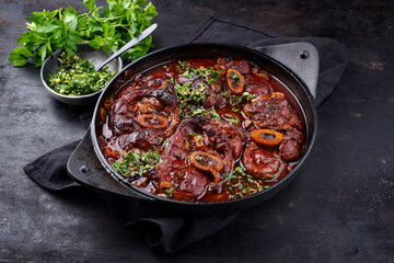 Traditional braised Italian ossobuco alla Milanese with gremolata in white wine and veal sauce...