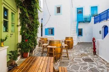 Narrow streets of Plaka village with traditional white houses with typical Greek architecture,...