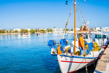 Unidentified fisherman on his fishing boat in Pollonia port, Milos island, Cyclades, Greece