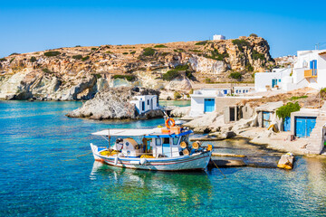 Fishing boat at Rema beach in beautiful sea bay, Kimolos island, Cyclades, Greece - obrazy, fototapety, plakaty
