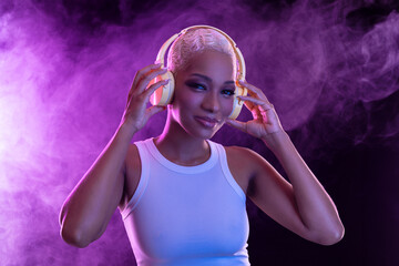 Hipster fashion girl, african american model wear headphones enjoy listen new cool music mix. Woman...