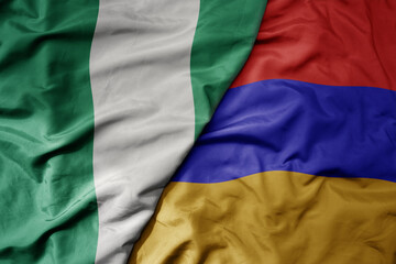 Obraz premium big waving national colorful flag of armenia and national flag of nigeria .
