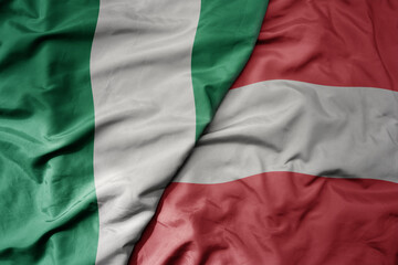 Obraz premium big waving national colorful flag of austria and national flag of nigeria .