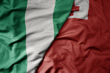 Obraz premium big waving national colorful flag of Tonga and national flag of nigeria .