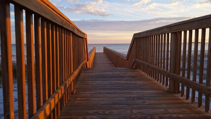 A boardwalk leading to the seashore on a beach in Pensacola, Florida, USA.