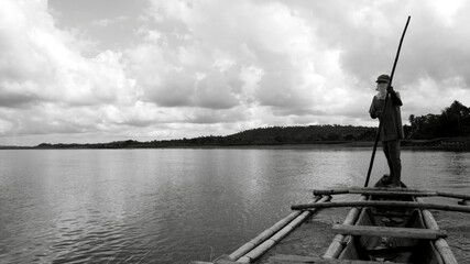 A black and white photograph of a wooden boat driver in Tinapuay, Banga, Aklan.