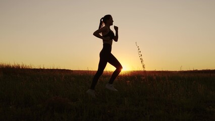 Running after sun. Training jogging. A healthy beautiful girl is engaged in fitness, jogging in...