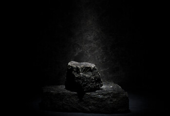 black granite for the pedestal stand. composition of stones on a dark background for product...
