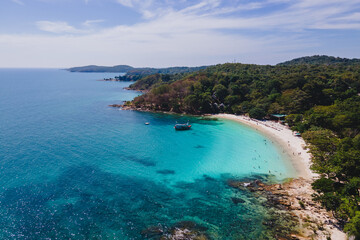 aerial drone view from above at the Samed Island in Thailand with a turqouse colored ocean and a white tropical beach view