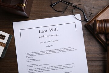 Last will and testament near glasses, gavel on wooden table, flat lay