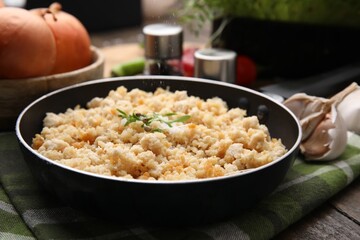 Salting minced chicken at wooden table, closeup