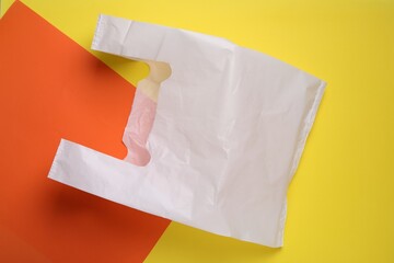 One plastic bag on color background, top view. Space for text