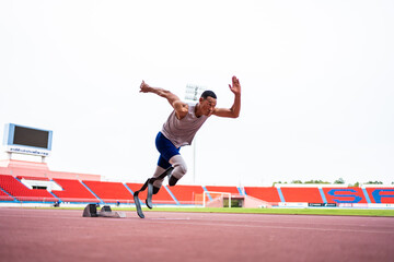 Asian para-athletes disabled with prosthetic blades running at stadium. 