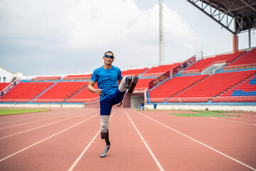 Portrait of Asian para-athletes disabled with prosthetic in stadium. 