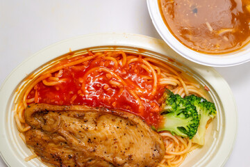 top view chicken cutlet with tomato and meat sauce pasta and bowl of crab roe flavored soup