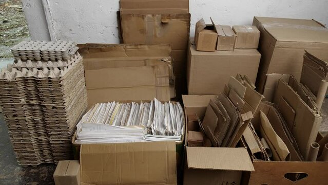 Paper waste recycle. Piles of used cardboard, packaging boxes, egg cartons, newspapers and office copy paper for recycling