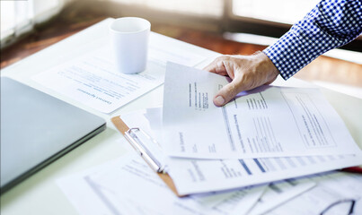 Hand of businessman or lawyer holding business contract and important bucuments verify the...