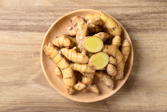 Fresh white turmeric in wooden bowl, Spice in Asian cuisine, Table top view