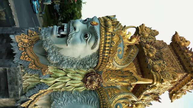Vertical aerial view of the incredible and detailed statue in Benoa on the island of Bali. The statue is installed on the road, at the roundabout. Historical and religion statues in Bali.