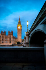 Amazing view of majestic historic palace and historical buildings with columns and arched passage near Big Ben against clock tower on cloudy day in London