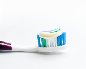 Toothbrush with toothpaste on white background