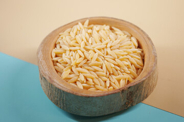 Wooden bowl with white long rice basmati.