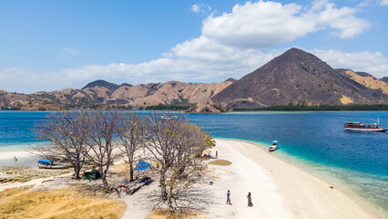 Panorama view of beaches and tourist boat sailing in Kelor Island, Flores Island, Indonesia