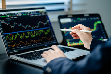 Investor analyze and valuation the stock market index digital tablet screen to trade the stock...