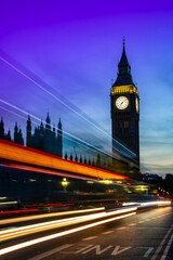Fototapeta na wymiar Public transportation bus and cars on asphalt road near Big Ben or Clock Tower under picturesque sky in dusk in London city at night