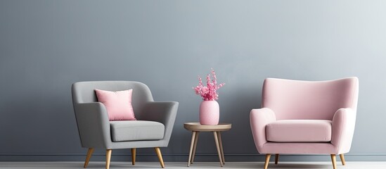 Gray armchair with pink accessories next to bed in bedroom.