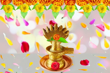 golden metal shivalinga idol for adoration to lord Shiva hindu god with flower garland,flower petal,bael leaves - obrazy, fototapety, plakaty