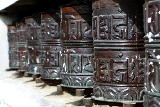 Buddhist prayer wheels. Decorated Buddhist prayer wheels in a stupa.