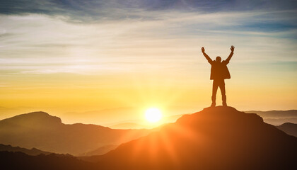 Silhouette of man celebrating raising arms on top of mountain and sunset. concept successful achievement with goal, growth, up, leadership, win and objective target - obrazy, fototapety, plakaty