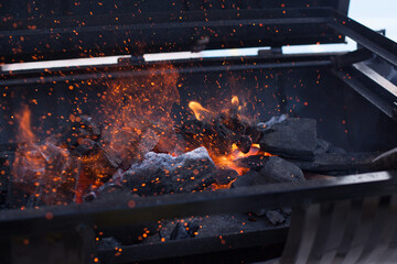 Photograph of charcoal grill ignited. Food preparation concept.