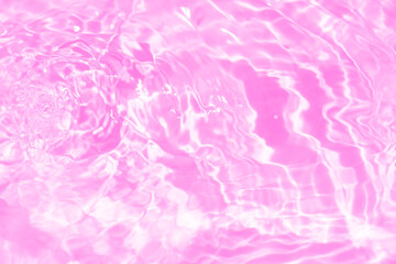 Fototapeta premium Pink water bubbles on the surface ripples. Defocus blurred transparent purple colored clear calm water surface texture with splash and bubbles. Water waves with shining pattern texture background