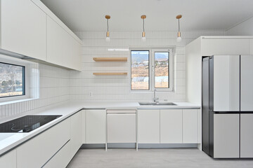 A modern kitchen built with wall tiles, which are popular these days
