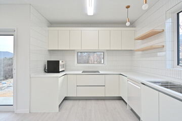A modern kitchen constructed with wall tiles, which are popular these days