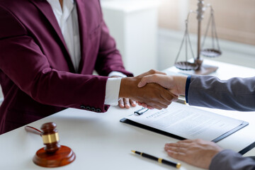 Businessman handshake to seal a deal with his partner lawyers or attorneys discussing a contract agreement.
