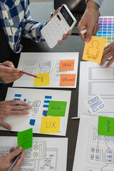 UX developers or company employees design user interfaces or UI prototypes for mobile applications...