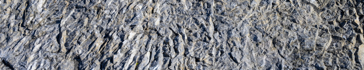 Roughly textured medium gray rock, as a nature background
